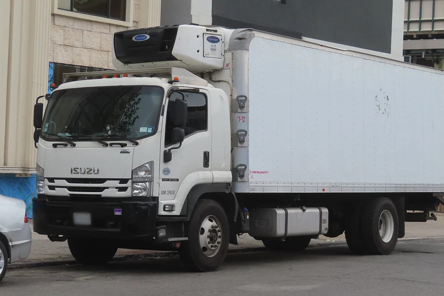 White Isuzu FTR cab-over truck with a refrigerated box