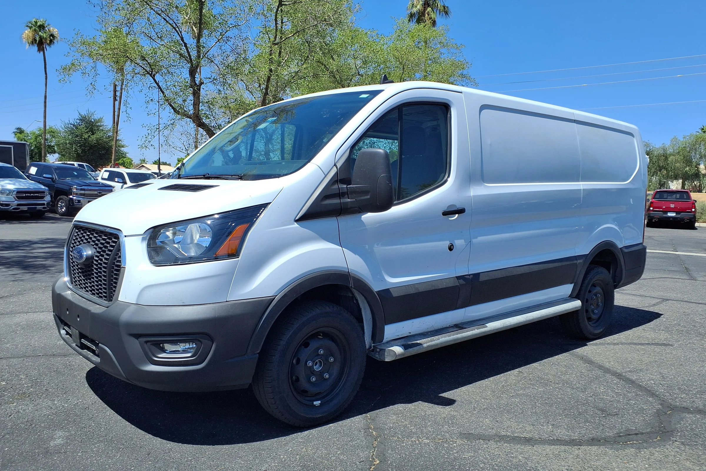 White Ford Transit 250 cargo van, front three-quarter view